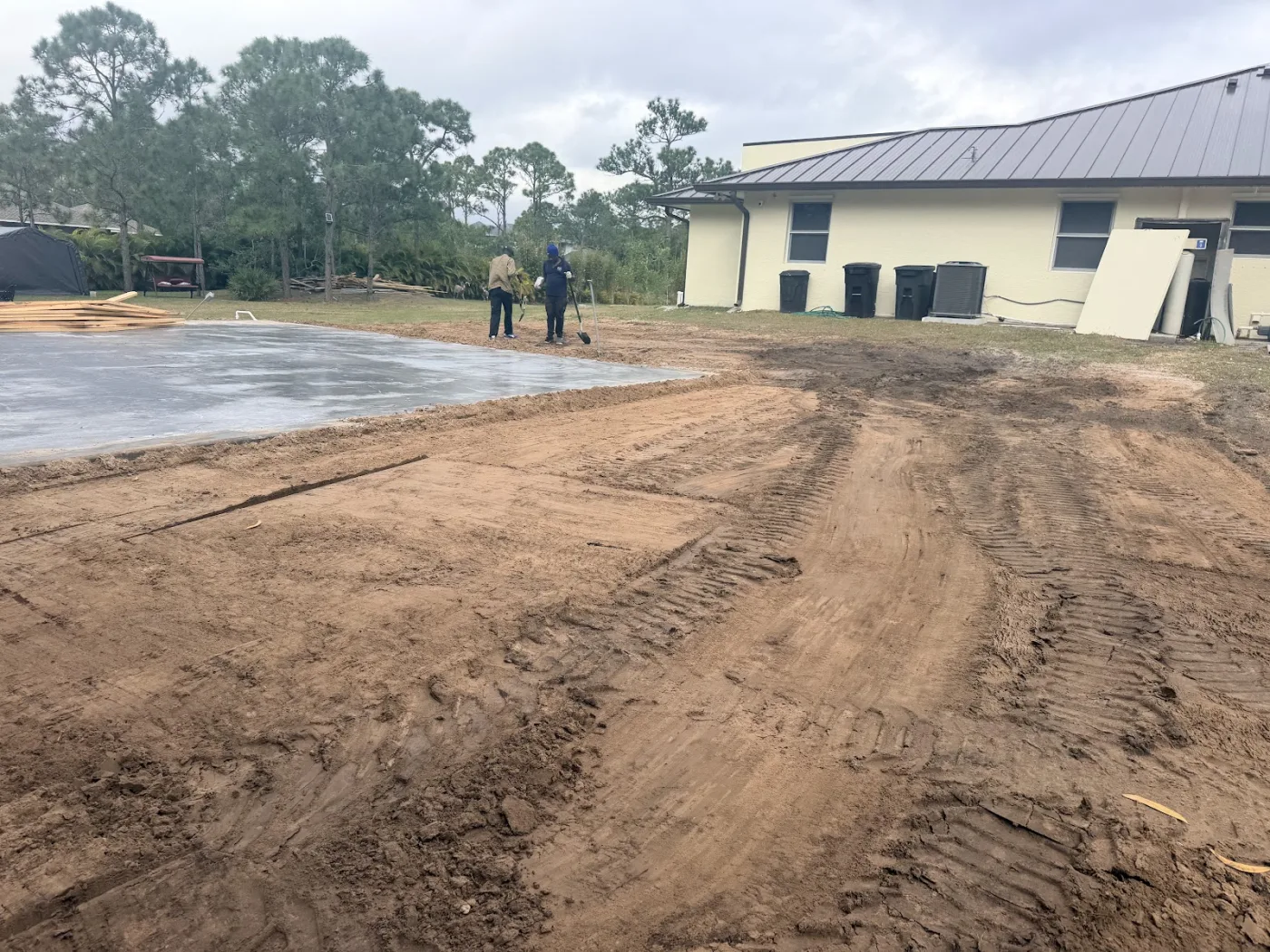 Dirt spread and leveled beside a building pad